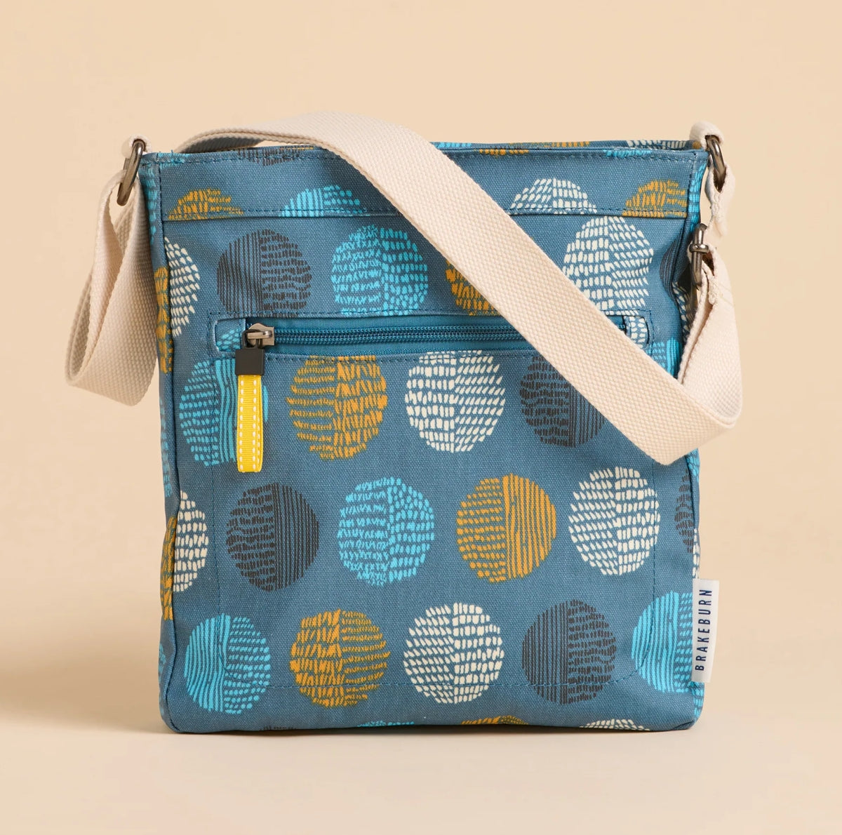 Brakeburn cross body bag teal spot with adjustable cream strap and multicolor circular patterns