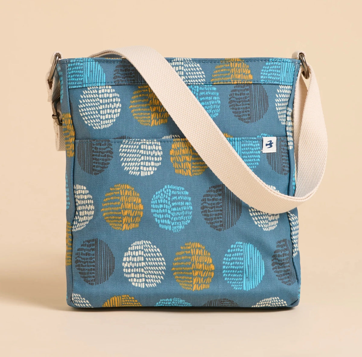 Brakeburn cross body bag teal spot with adjustable cream strap and colorful circular pattern