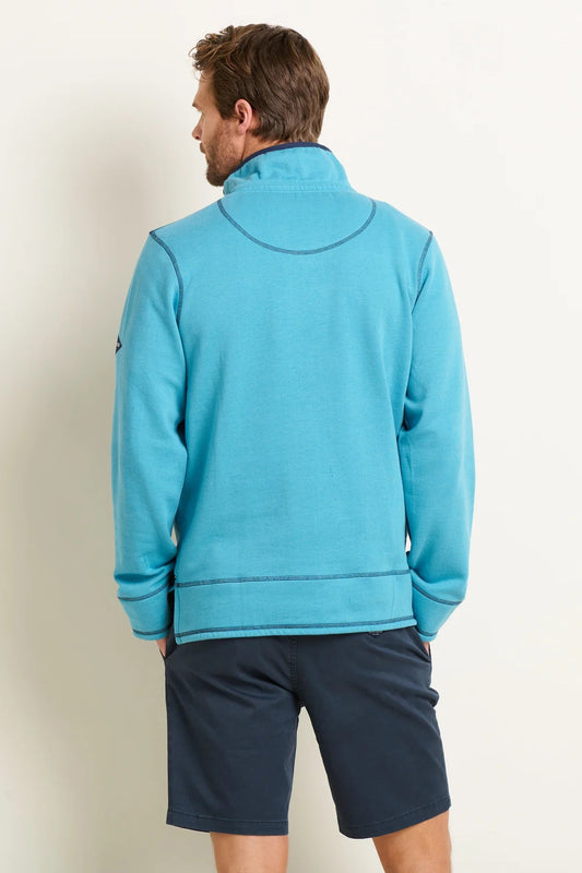 Rear view of a man wearing a Brakeburn mens blue sweatshirt with long sleeves and a high collar