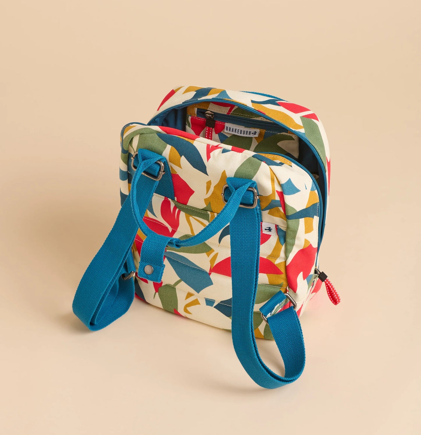 Brakeburn multicoloured print backpack with vibrant leaf pattern and adjustable blue straps