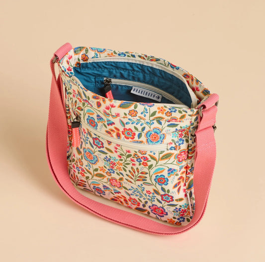 Brakeburn Secret Garden floral cross body bag with pink adjustable strap and vibrant flower print