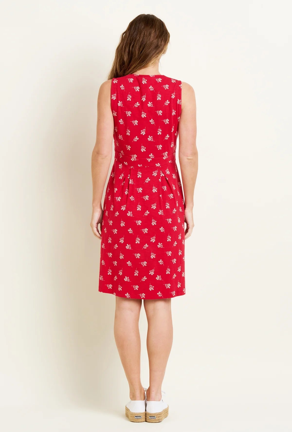 Back view of Brakeburn sleeveless dress red with white floral print worn by woman