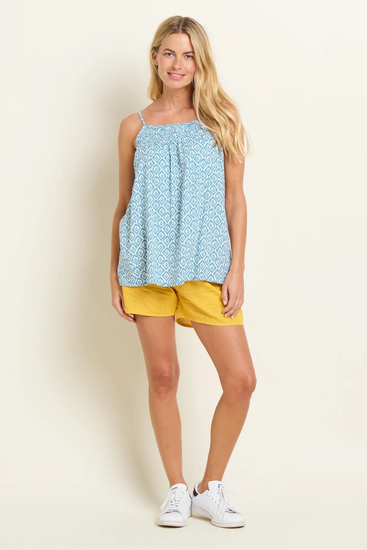 Brakeburn womens blue camisole vest with geometric pattern worn with yellow shorts and white sneakers