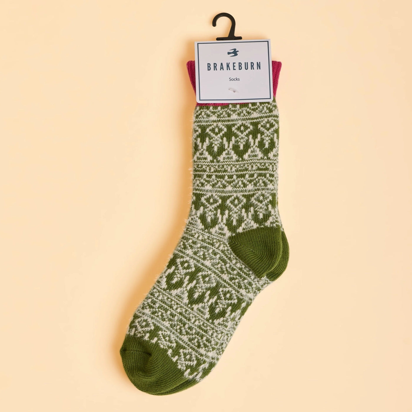 Green Brakeburn womens socks with a white Nordic pattern on a beige background, featuring 'Brakeburn' brand label.