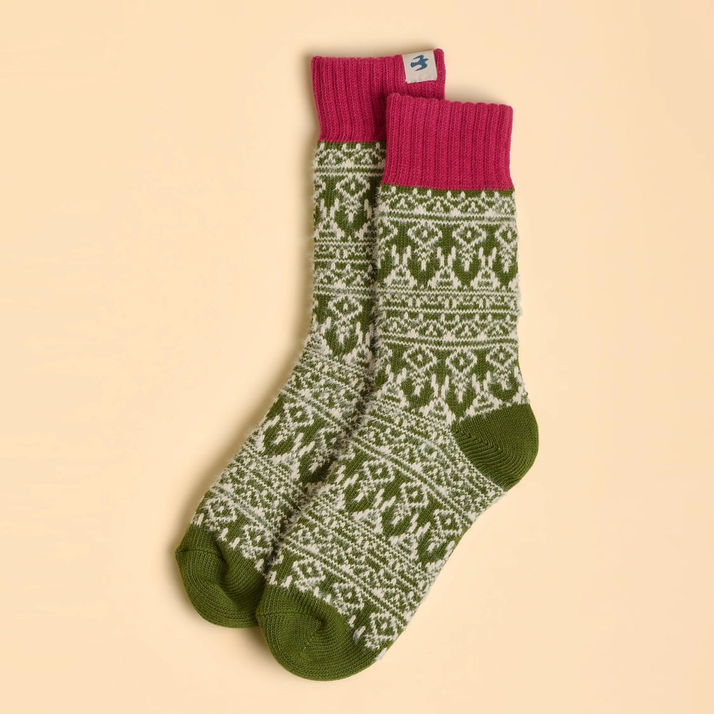 Womens Brakeburn green and pink Nordic patterned socks on a beige background
