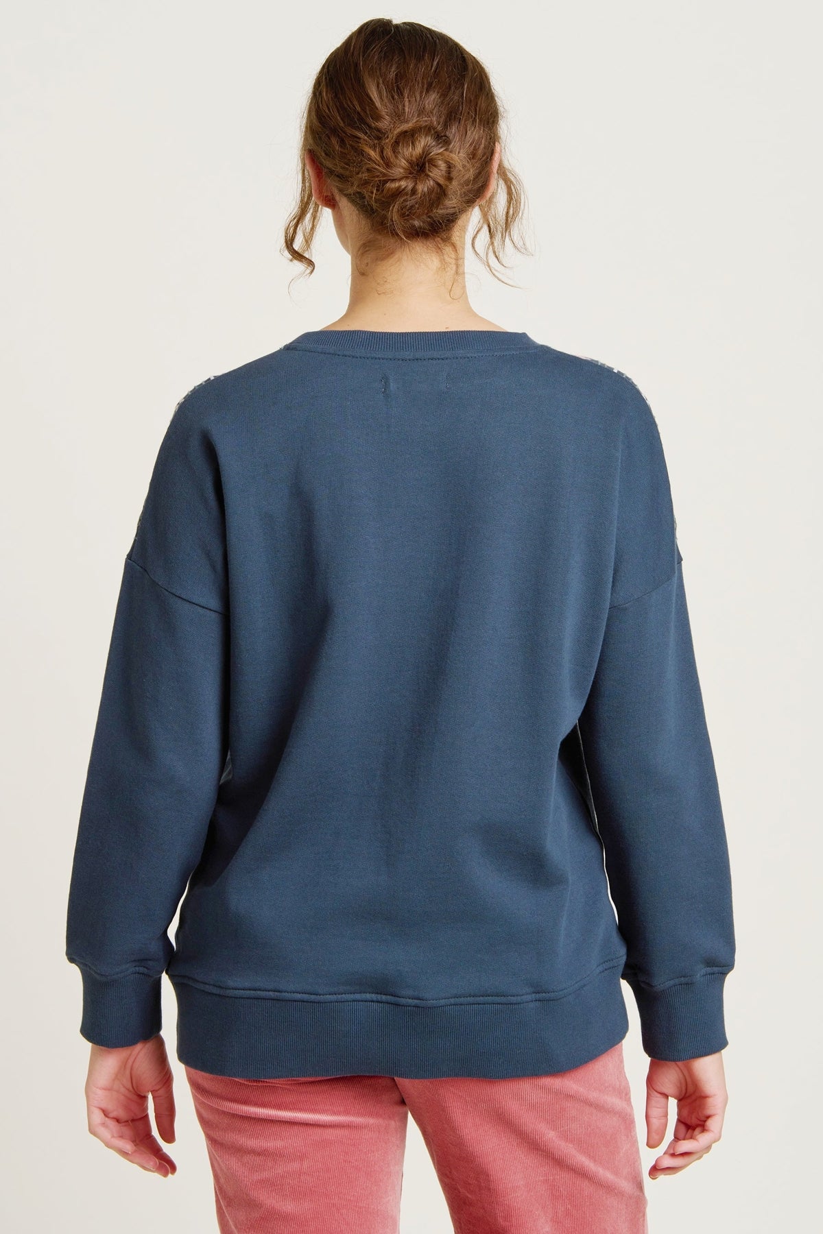 Brakeburn womens crew sweatshirt blue shown from the back on a model with long sleeves and relaxed fit
