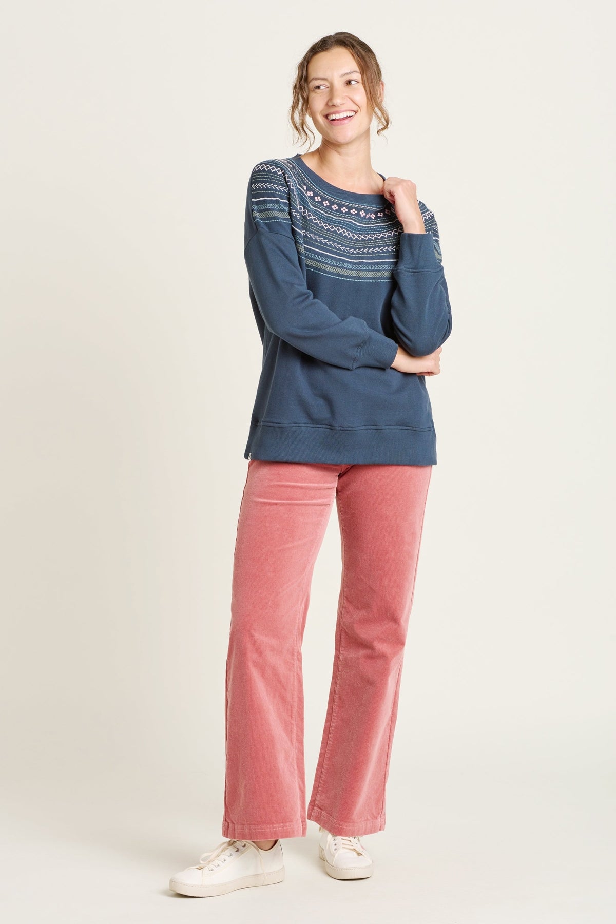 Brakeburn womens crew sweatshirt blue with patterned yoke worn by smiling woman in pink pants