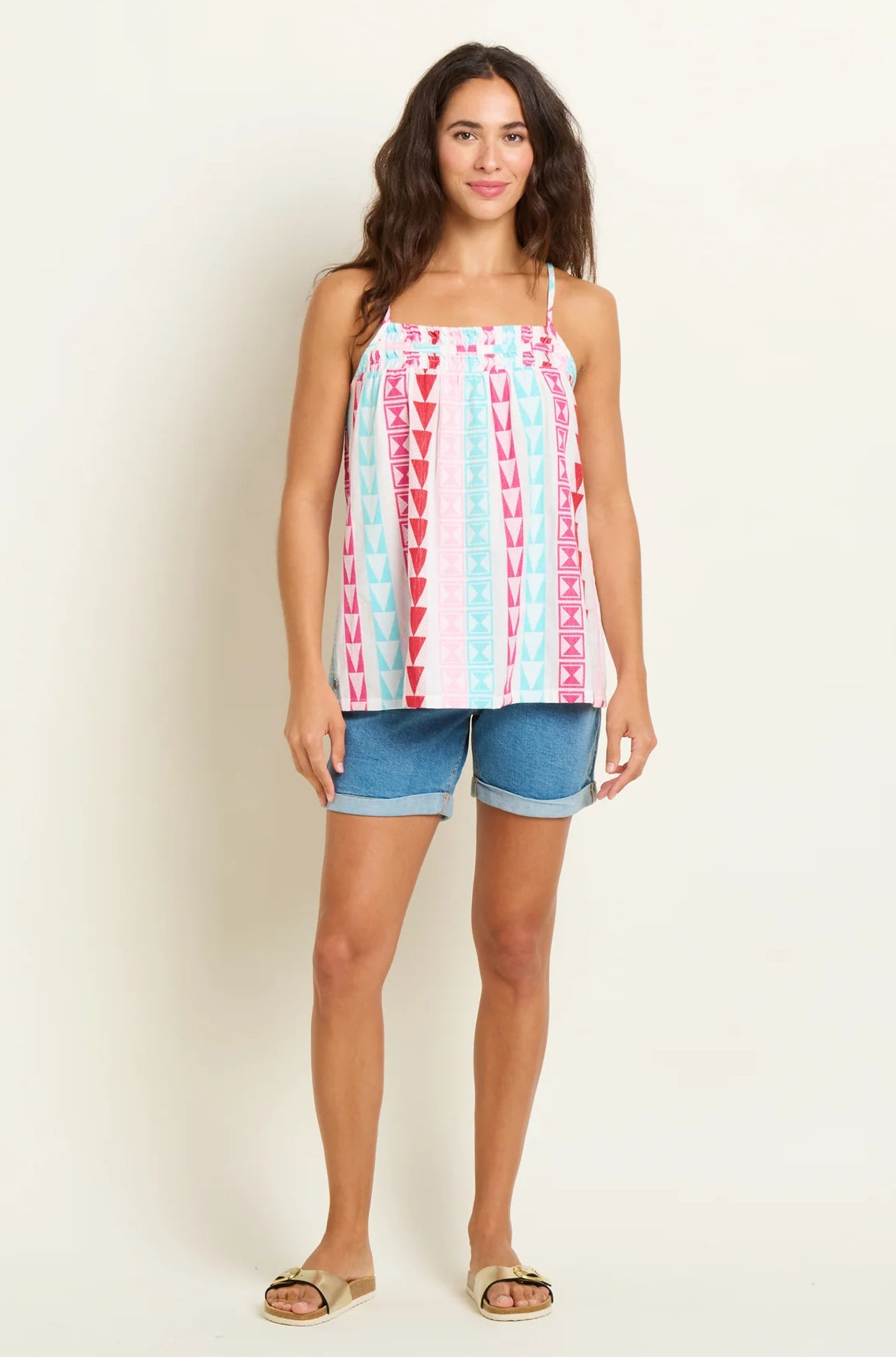 Brakeburn womens Rosie vest in white with red and turquoise geometric patterns worn with denim shorts