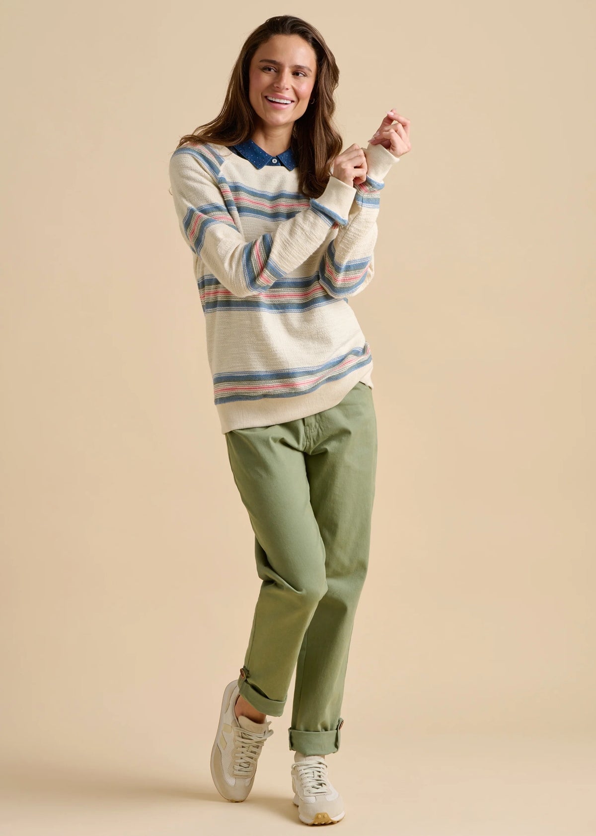 Brakeburn womens stripe jumper sweat with blue collar worn by smiling woman paired with green pants and white sneakers