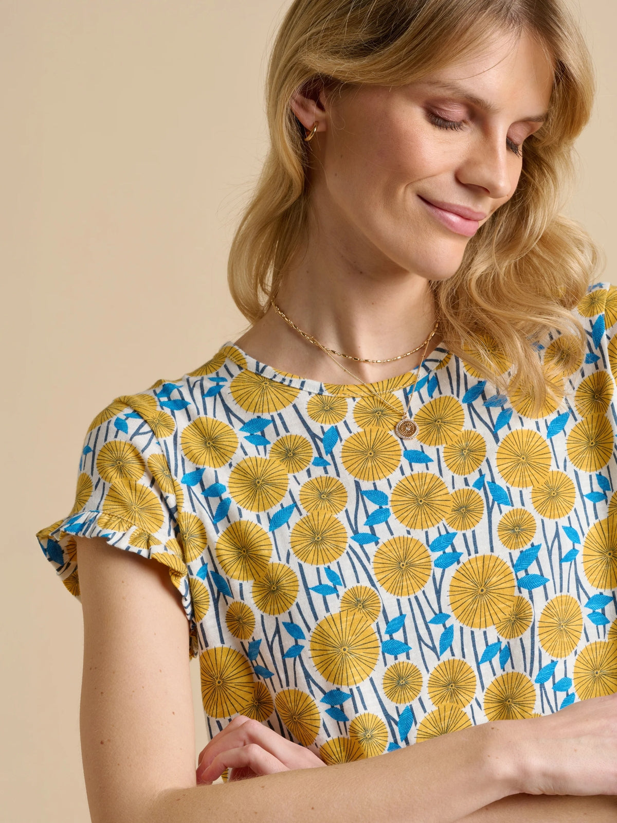 Brakeburn womens yellow t-shirt with floral print and short ruffle sleeves on model