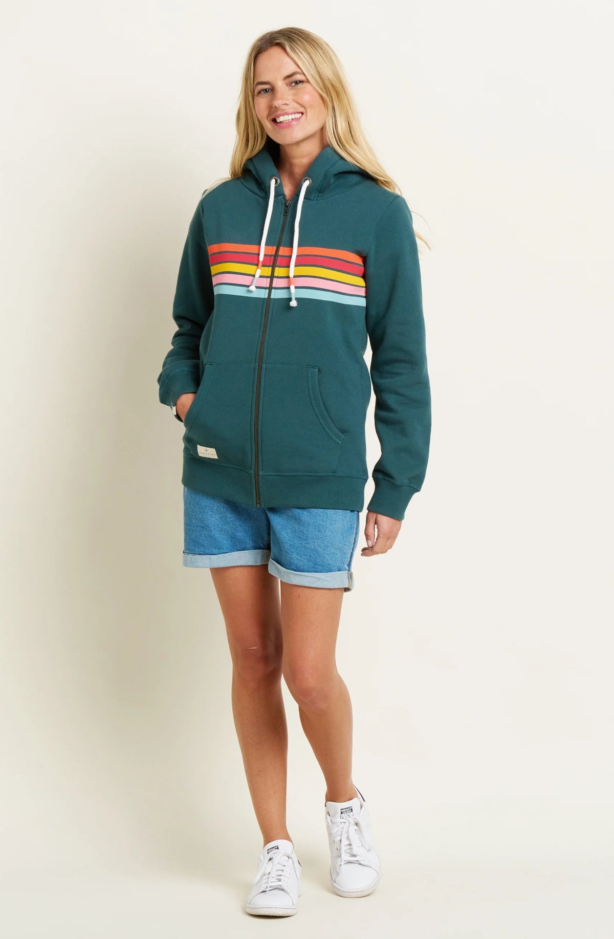 A full zip women's hoodie from Brakeburn with multicoloured printed stripes on the chest and front pockets.