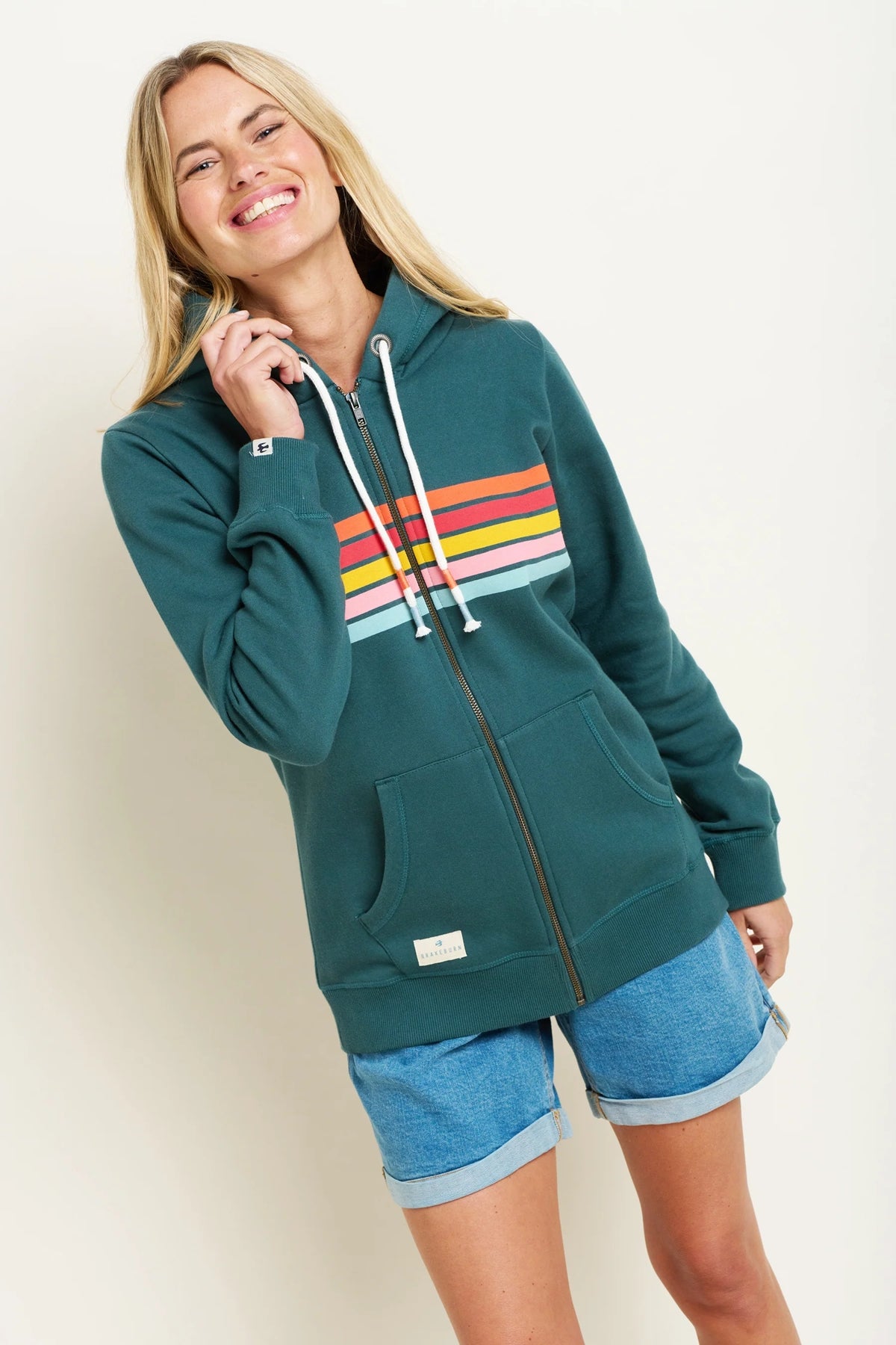 Teal coloured full zip women's hoodie from Brakeburn with multicoloured Retro stripes across the chest.