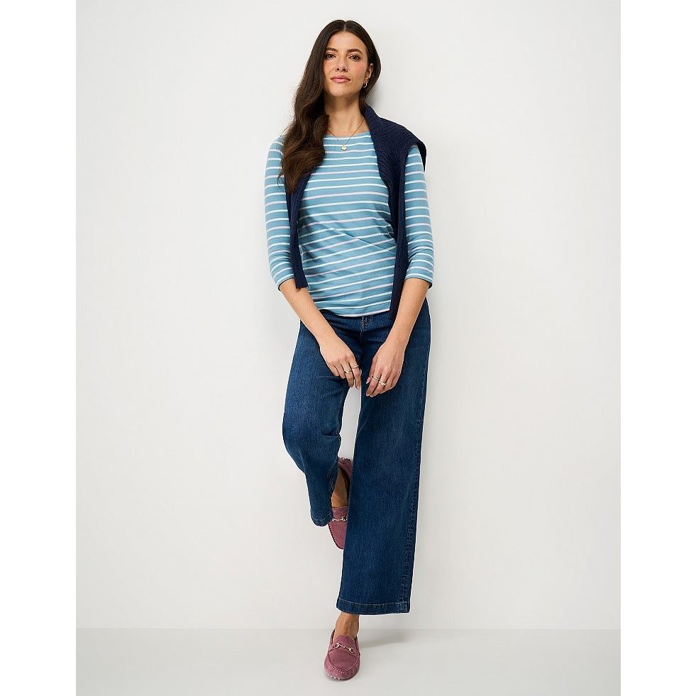 A woman wearing a Crew Clothing Essential Breton 3/4 sleeve t-shirt in Delph Blue with pale pink and white stripes.