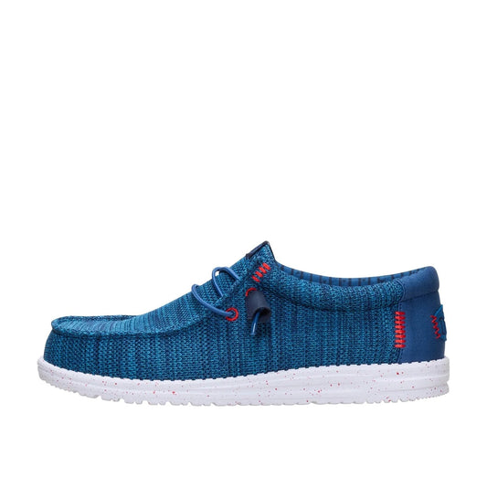 Side view of a men's Dude Wally Stretch Sox lightweight mesh shoe in Ensign Blue / Multi, with elastic laces and a white speckled sole.