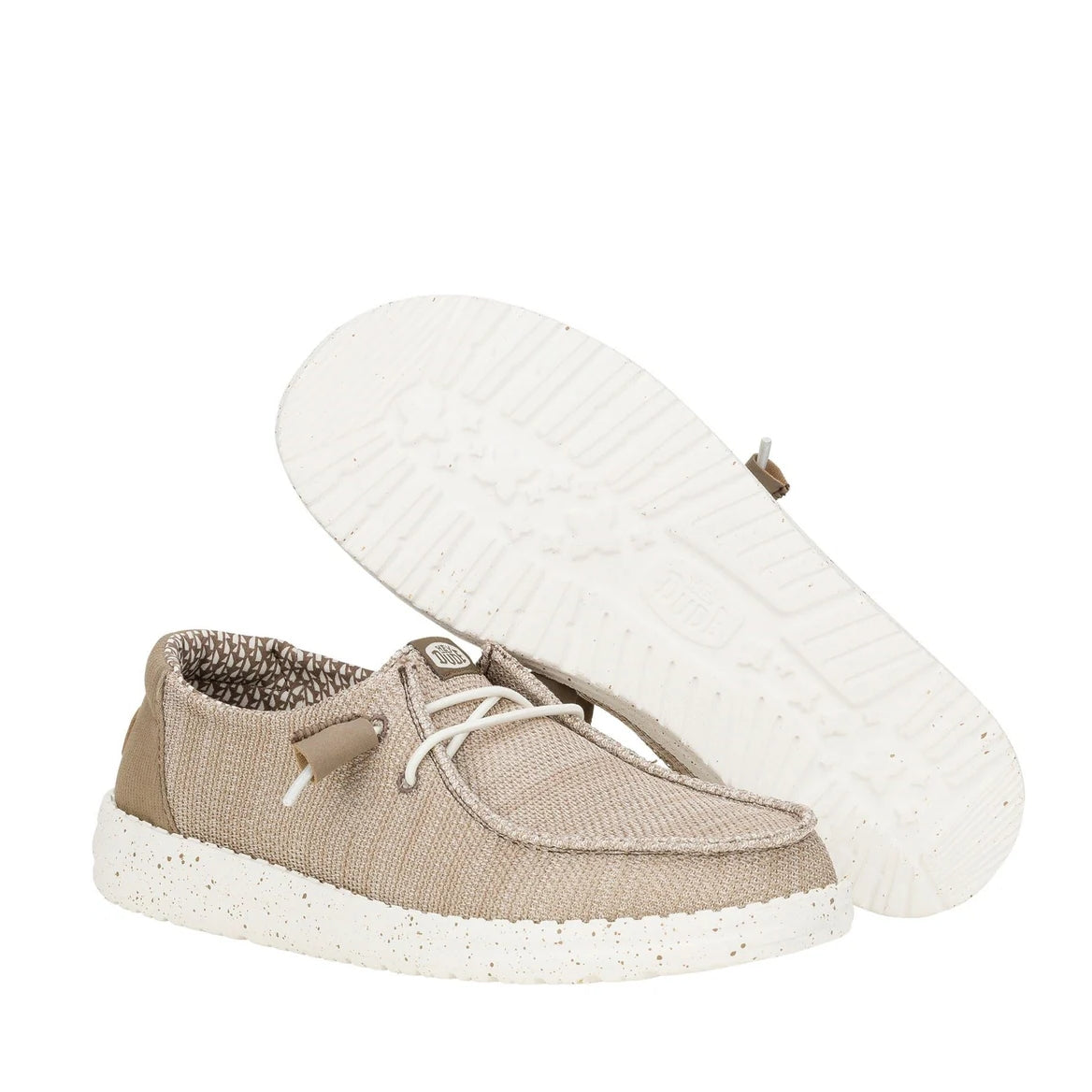A pair of women's Dude Wendy Stretch Sox shoe in Walnut beige/brown, showing the bottom white outsole of one shoe.