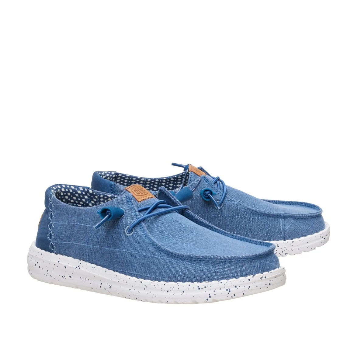 A pair of women's Dude Wendy Chambray Grid shoe in Ensign Blue, featuring matching blue elastic laces, speckled white soles and brown Hey Dude logo on the tongues.