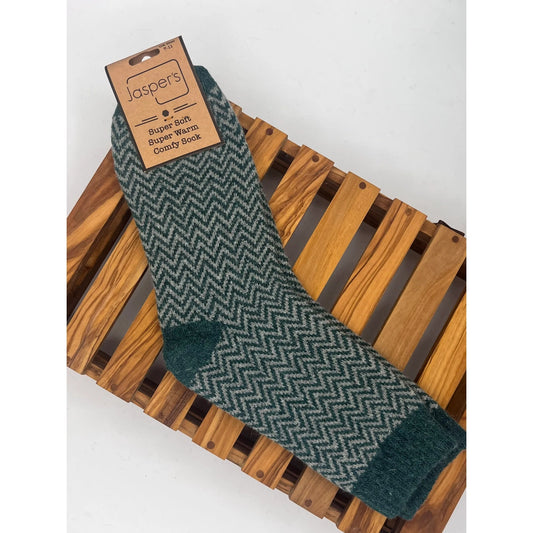 Pair of mens wool Jaspers socks in green with a herringbone pattern on a wooden crate
