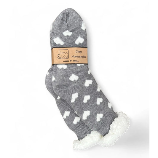 Grey womens slipper socks with white heart pattern and white fluffy lining, featuring a 'Jess & Lou' label.