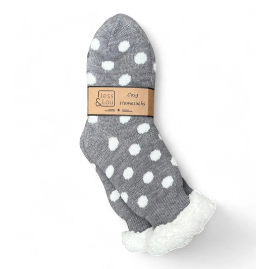 Womens grey slipper socks with white polka dots and fluffy white lining on a white background, featuring a Jess & Lou label.