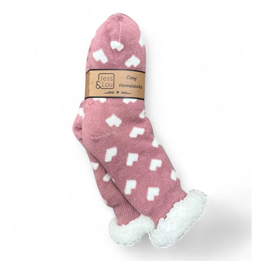 Pink womens slipper socks with a white heart pattern and a white fluffy lining on a white background, featuring a 'Jess & Lou' label.