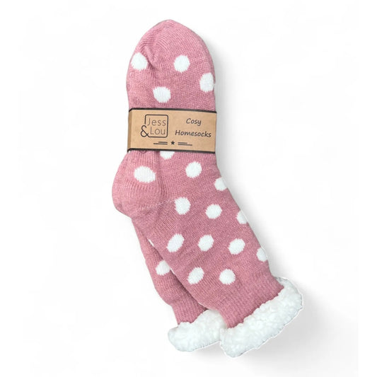 Womens pink polka dot slipper socks with a white fluffy lining on a white background, featuring Jess & Lou branding.