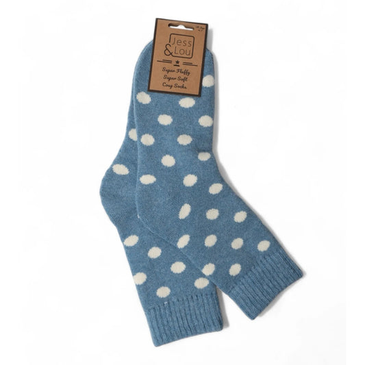 A pair of womens Jess and Lou cosy wool socks in blue with a white spot pattern on a white background