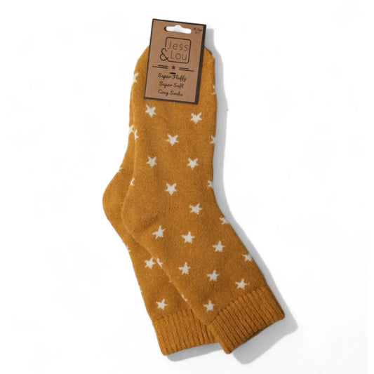 Gold yellow cosy wool socks with a white star pattern on a white background, featuring a Jess & Lou label.