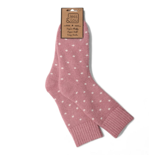 A pair of womens Jess and Lour pink polka dot cosy socks with a label on a white background