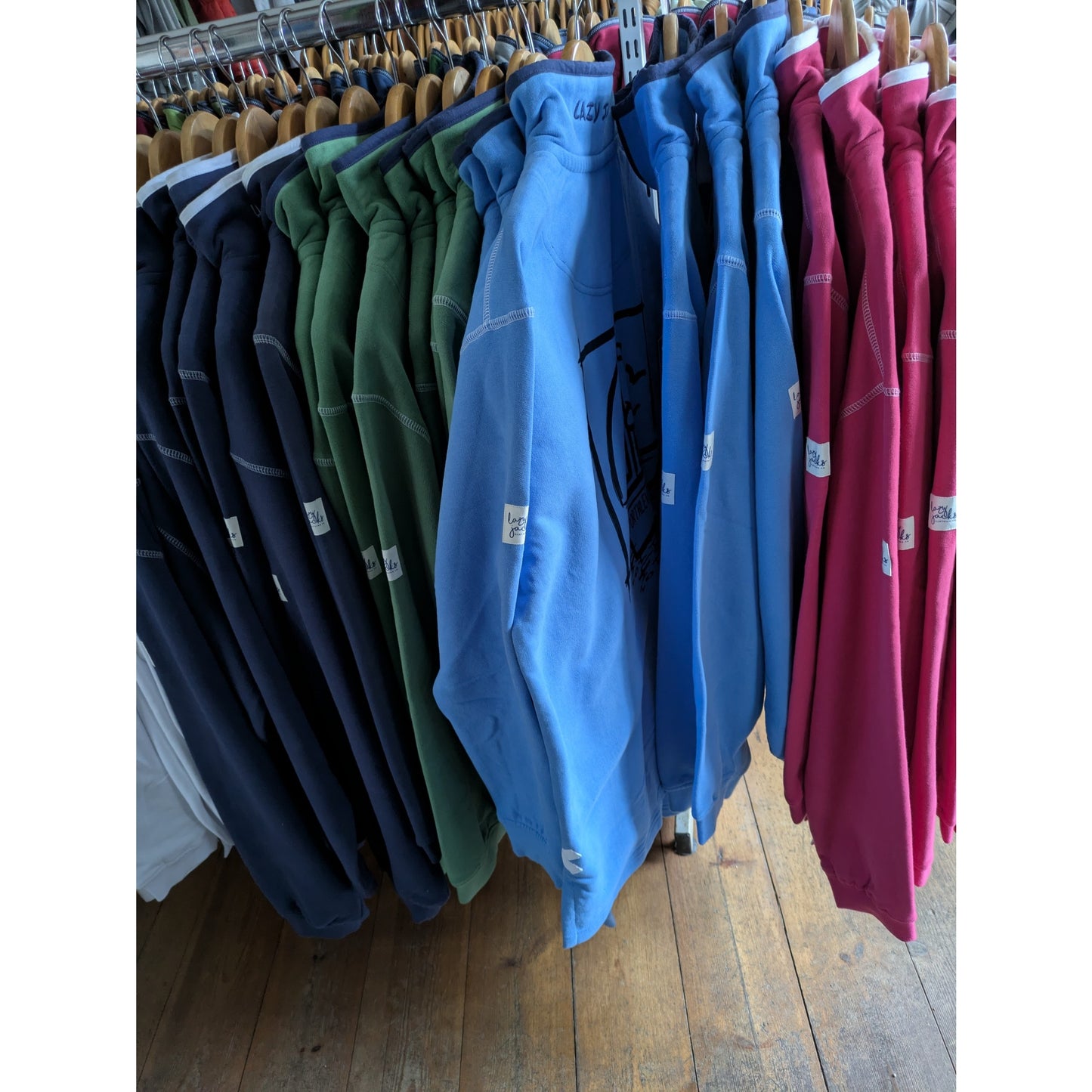 Selection of womens Lazy Jacks LJ3 zip neck sweatshirt in cherry, navy, blue, white and green on a shop rail