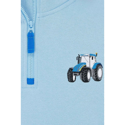 Close-up view of a Weird Fish kids Jonah 1/4 zip neck sweatshirt with blue trim and blue tractor applique sewn on the chest.