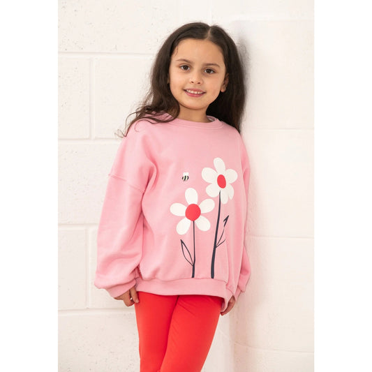 Front view of a Lighthouse kids Flora sweatshirt Dusky Pink flowers with white floral design worn by girl