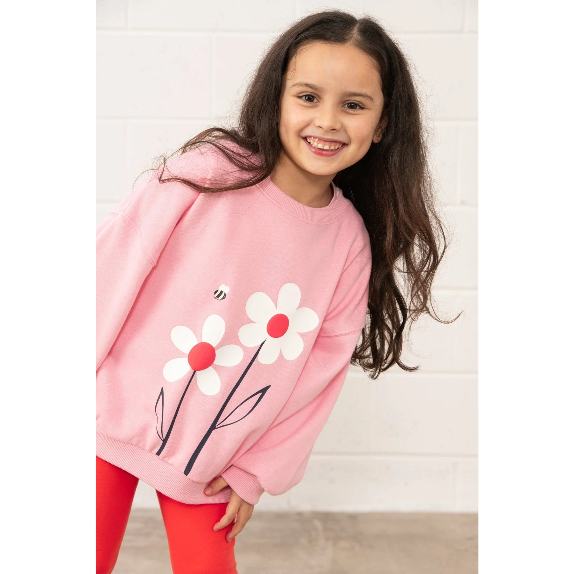 Lighthouse kids Flora sweatshirt Dusky Pink flowers worn by smiling girl with long hair