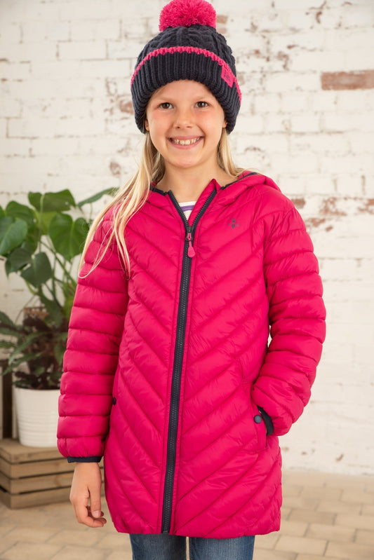Front view of a Lighthouse kids Georgia padded coat pink worn by smiling girl with knit hat indoors