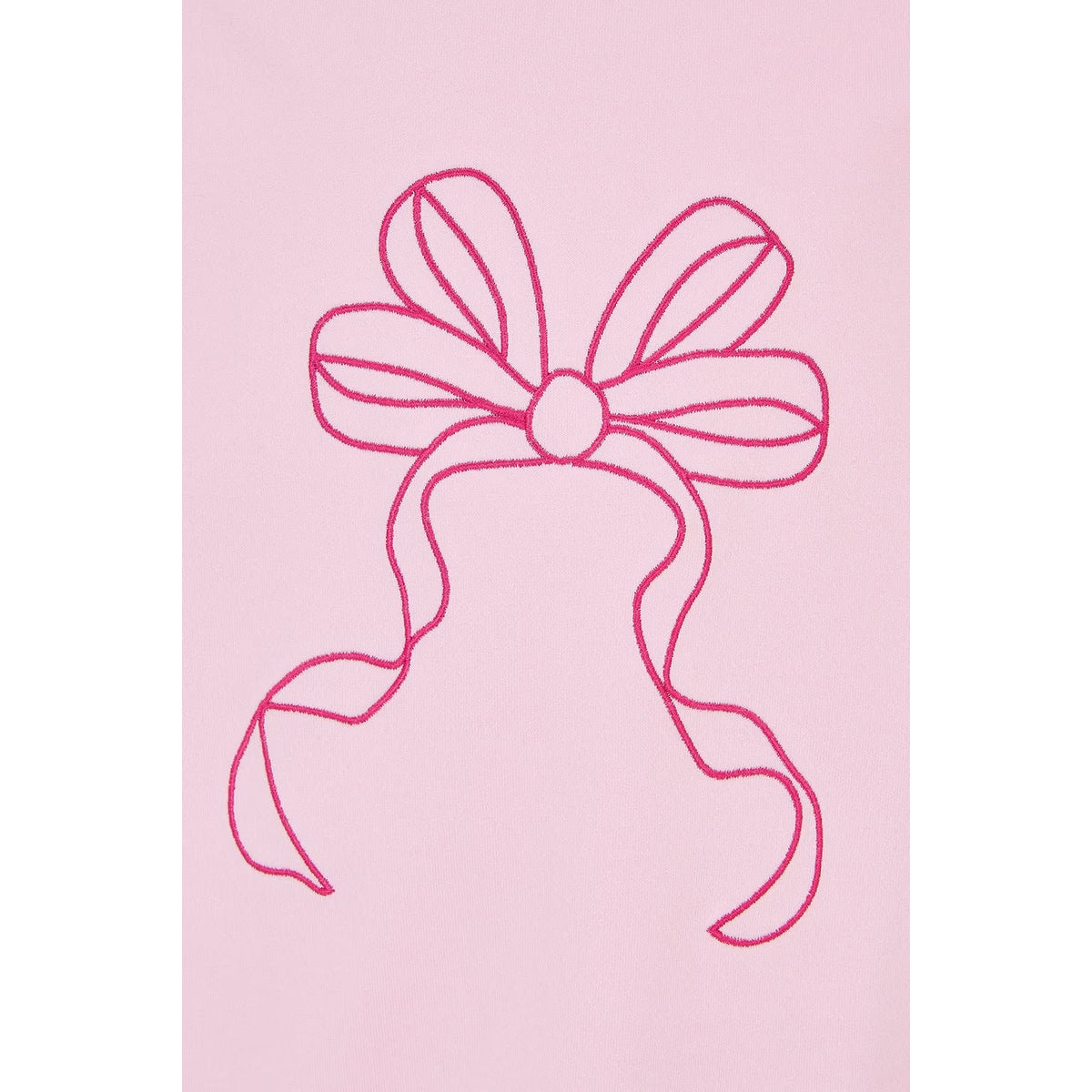 Close-up view of a kids Lighthouse Causeway short sleeve tee in pink with a tie hem and embroidered bow on the front.