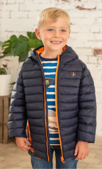 Lighthouse kids navy Carter padded coat worn by smiling boy with orange zipper and hood