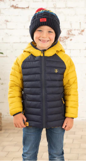 Lighthouse kids padded coat navy yellow worn by smiling child with navy knit hat and jeans