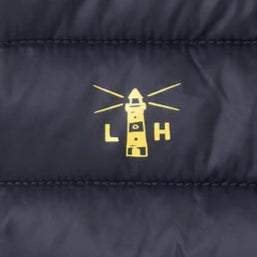 Close-up of Lighthouse kids padded coat navy yellow logo detail on navy fabric