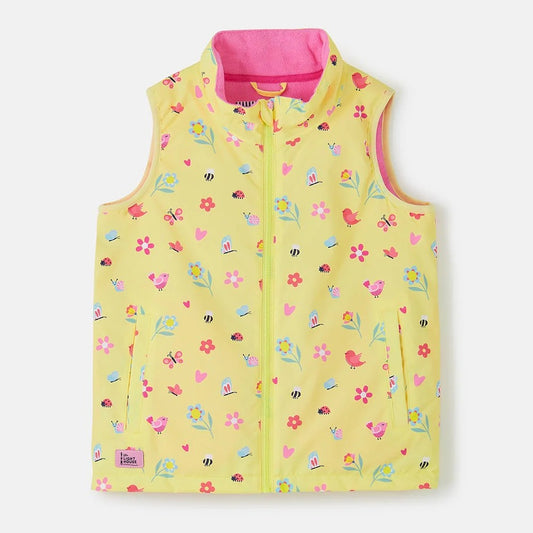 Front view of a Lighthouse kids yellow floral gilet with pink lining and colourful flower and bird prints