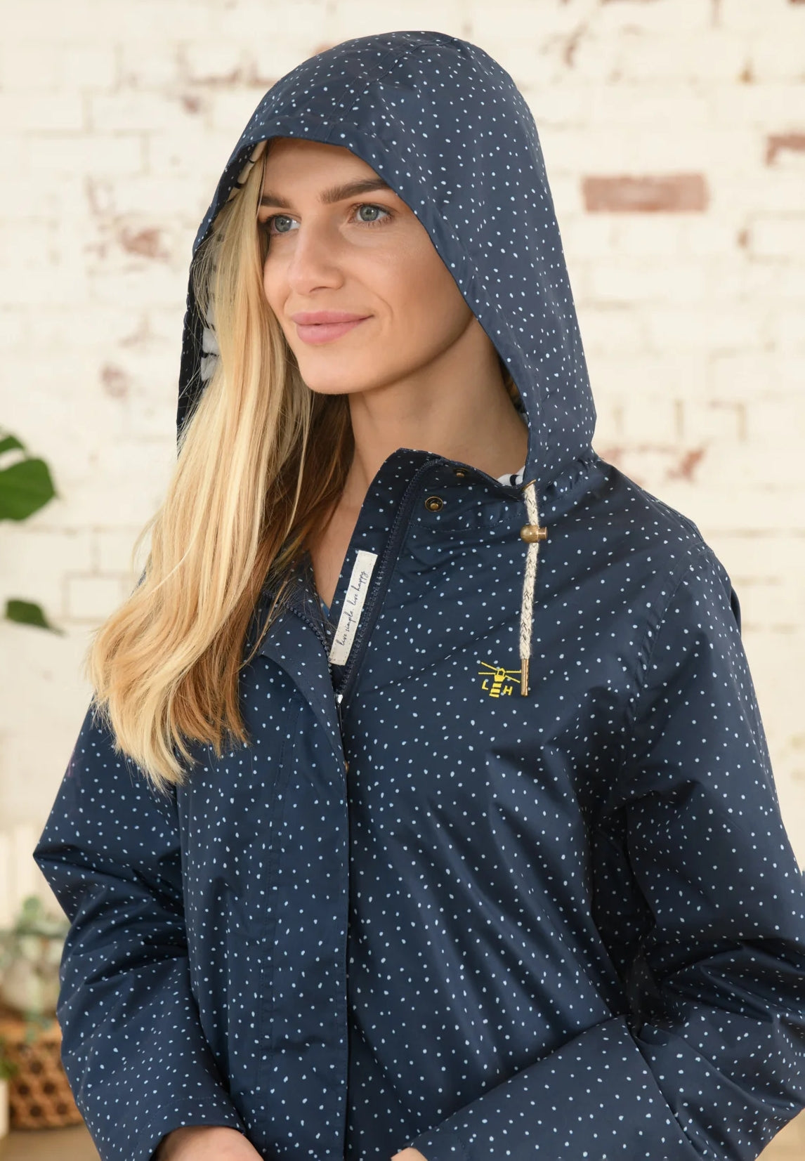 Lighthouse womens beachcomber jacket navy dot with hood and front zipper on blonde model