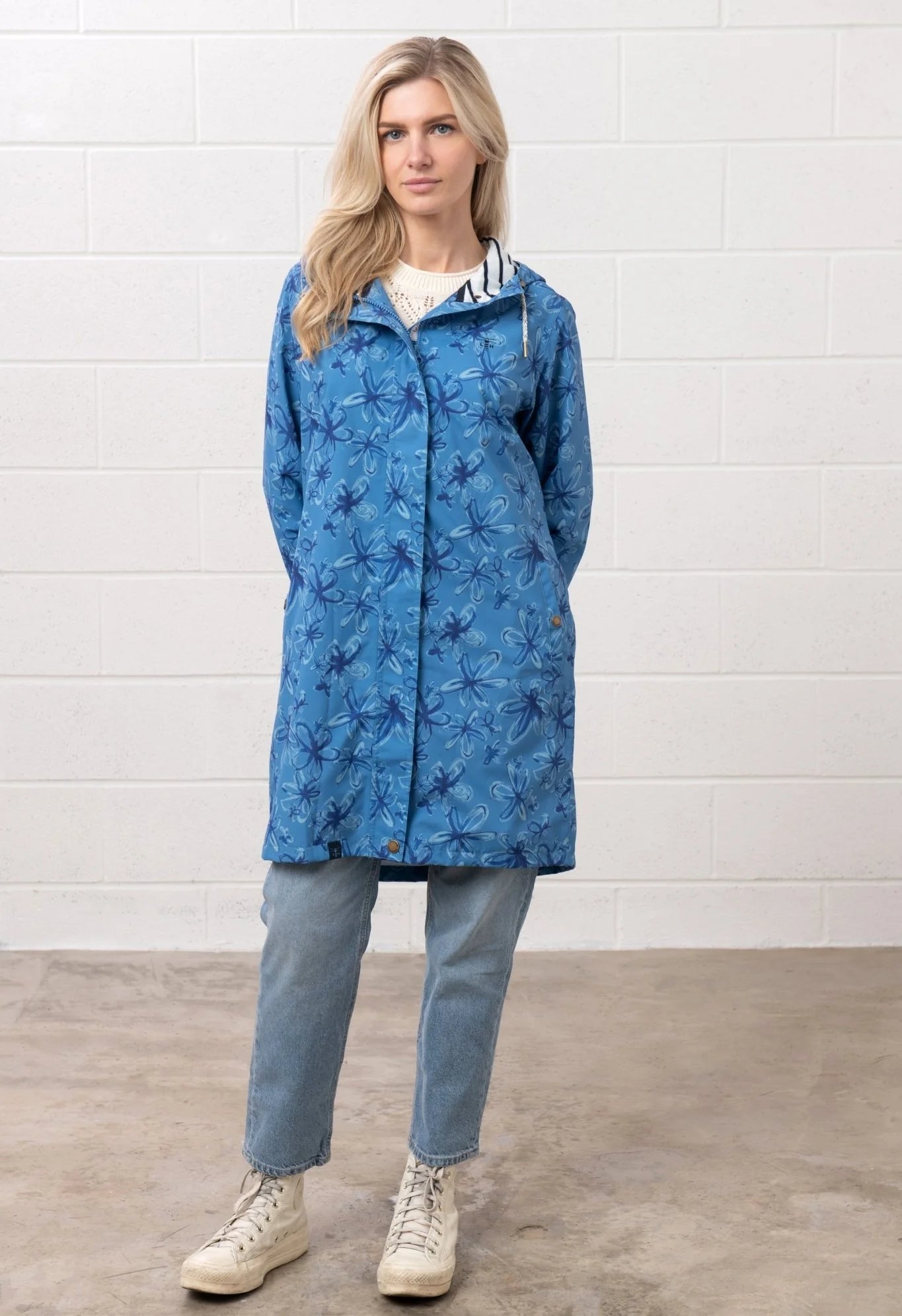 Lighthouse Womens blue floral jacket with hood worn by woman paired with jeans and boots