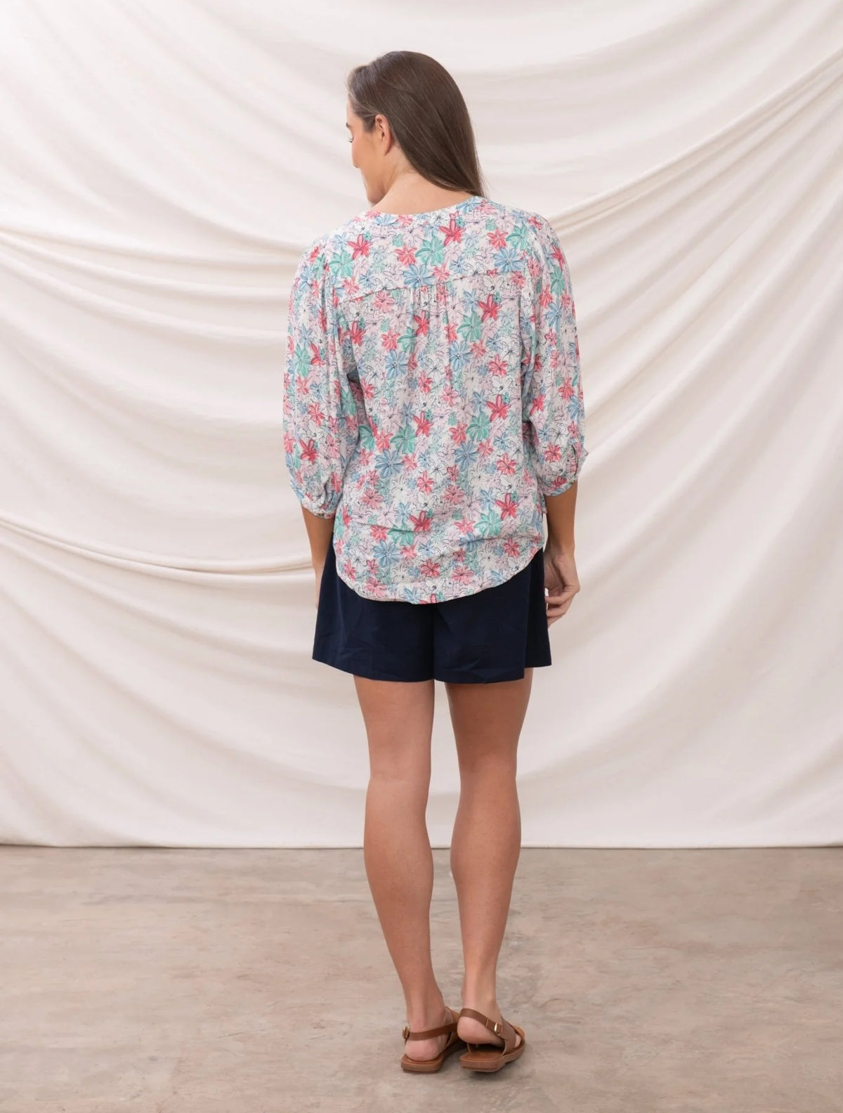 Lighthouse womens Lola floral blouse with pink and green flowers on light background shown from back