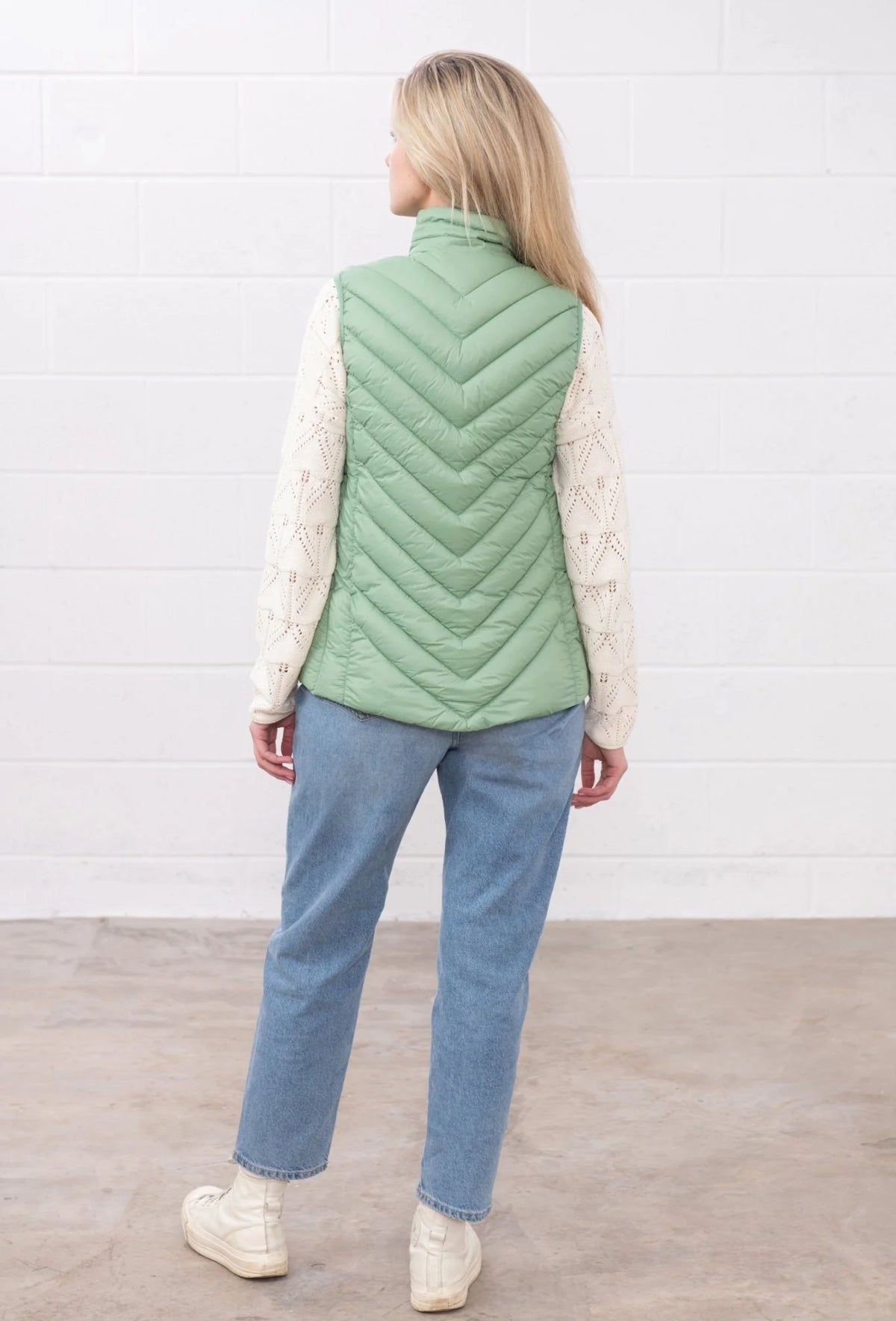 Lighthouse womens padded gilet green shown from the back worn with jeans and a sweater