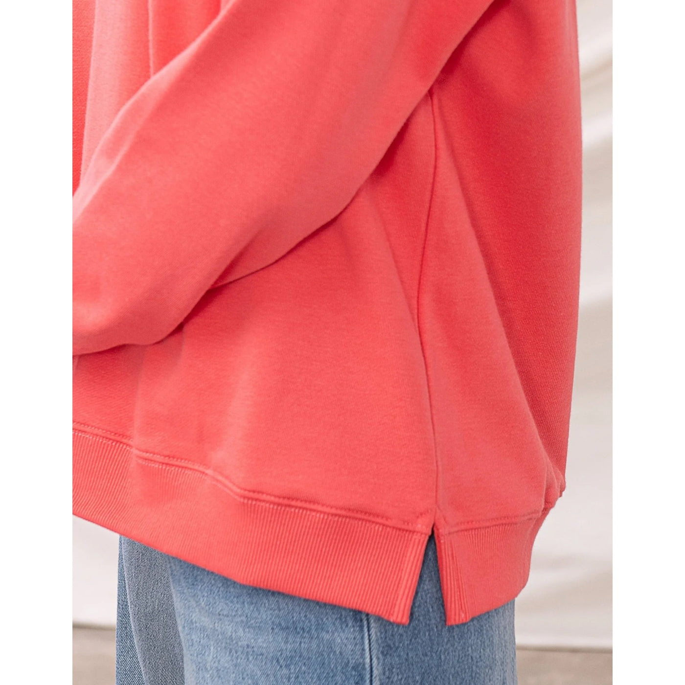 Coral womens Lighthouse sweatshirt with side hem slits on a white background
