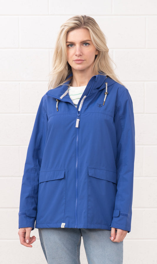 Lighthouse womens waterproof jacket in blue with hood and front pockets worn by a woman