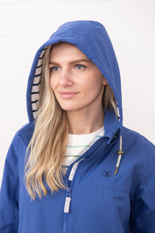Lighthouse womens waterproof jacket in blue with hood and front zipper on model