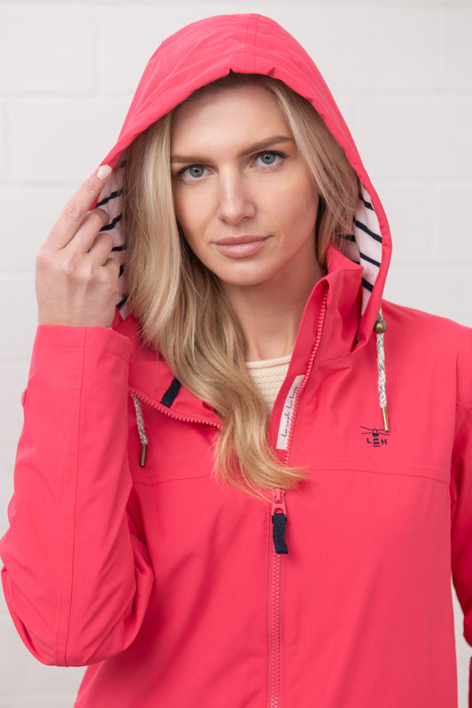 Lighthouse womens waterproof jacket raspberry with hood and zipper details on a blonde model