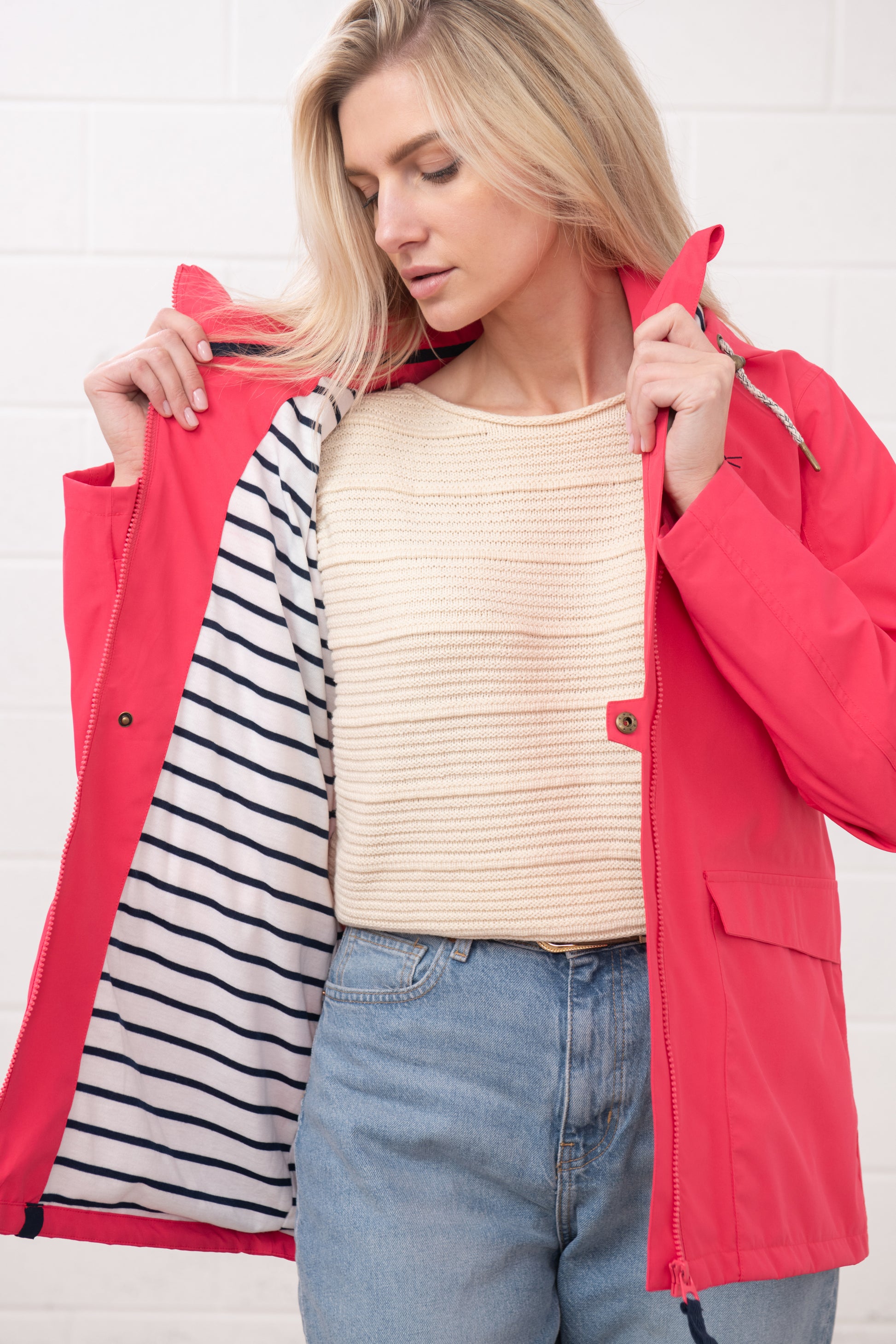 Lighthouse womens waterproof jacket raspberry shown open with striped inner lining on a blonde model