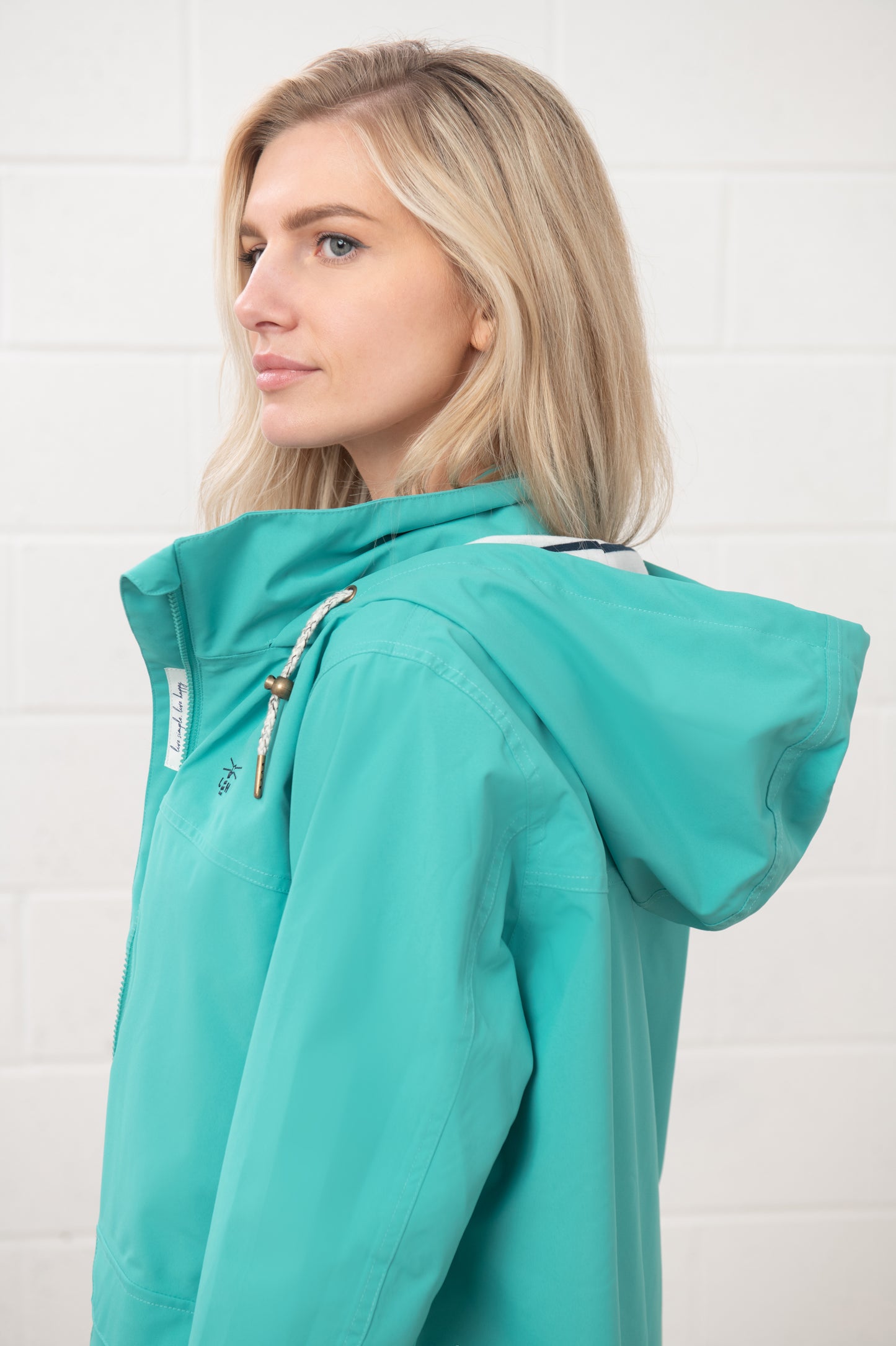 Lighthouse womens waterproof jacket teal with hood and adjustable drawstrings