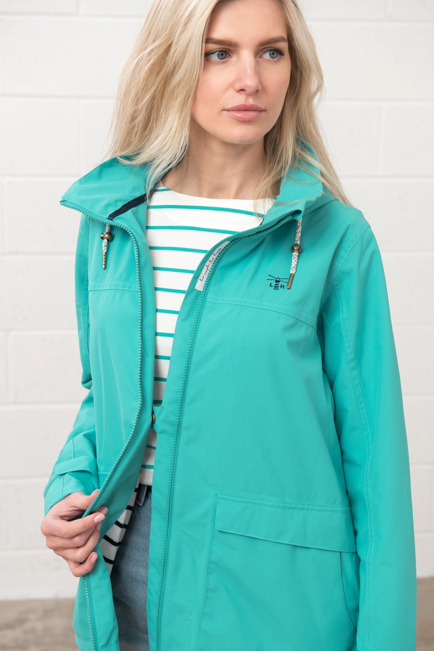 Lighthouse womens waterproof jacket teal on model with front zipper and hood