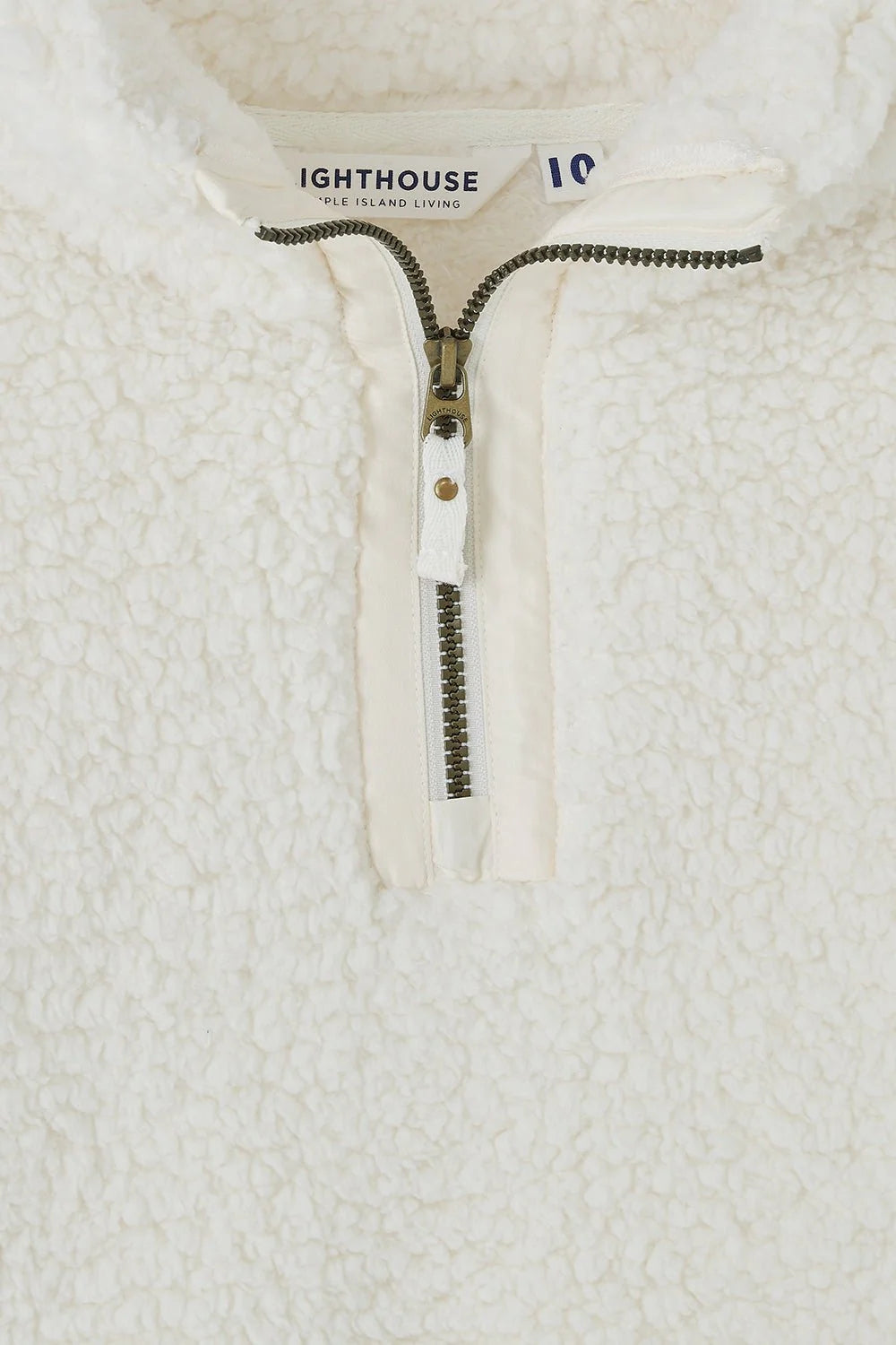 Close-up of white Lighthouse womens zip fleece with textured soft fabric and zipper detail